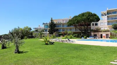 a resort with a swimming pool and a large building at Casa Jacqueline in Albufeira