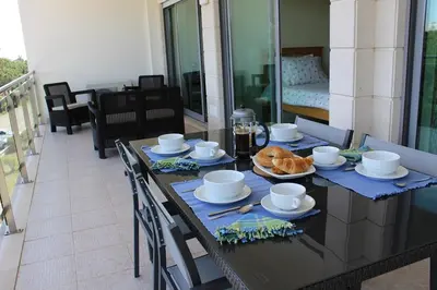 a dining table with food on top of a balcony at Casa Jacqueline in Albufeira