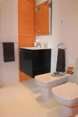 a bathroom with a white toilet and a sink at Casa Jaffa in Albufeira