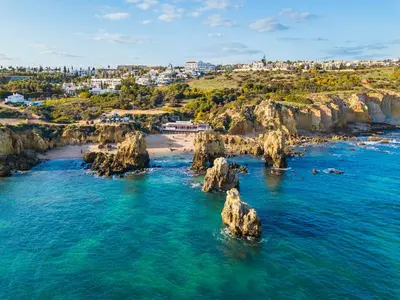 an aerial view of a beach with rocks in the water at Cozy Townhouse Vila Rafaella near São Rafael Beach Albufeira in Albufeira