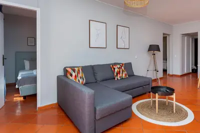 a living room with a couch and a table at Gorgeous 2BDR Apartment W/Patio & Pool by LovelyStay in Vilamoura