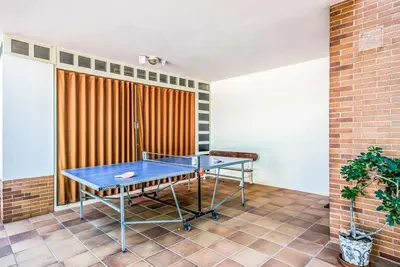 a ping pong table in a room with a brick wall at Villa Oceano in Patroves