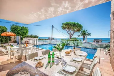 a dining room with a view of the ocean at Villa Oceano in Patroves