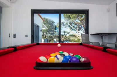 a pool table with a bunch of balls on it at Villa Videira By Dalma Portuguesa - By Dalma Portuguesa in Albufeira