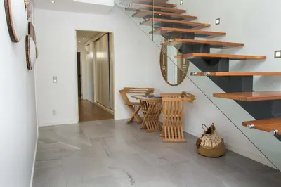 a staircase in a house with a table and chairs at Villa Videira By Dalma Portuguesa - By Dalma Portuguesa in Albufeira