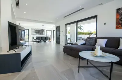 a living room with a couch and a tv and a table at Villa Videira By Dalma Portuguesa - By Dalma Portuguesa in Albufeira