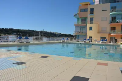 a large swimming pool in front of a building at Wonderful Apartment Albufeira Marina 4B 2B in Albufeira