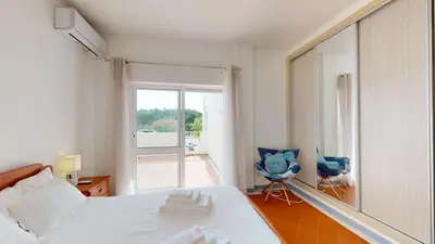 a bedroom with a bed and a large mirror at Apartamento Tranquilo T1 Albufeira 002 in Albufeira
