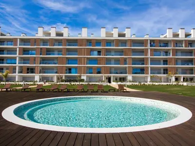 a hotel with a pool in front of a building at Green 2 Apartment by Stay ici Algarve Holiday Rental in Albufeira