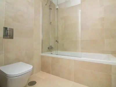 a bathroom with a shower and a toilet and a tub at Green 2 Apartment by Stay ici Algarve Holiday Rental in Albufeira