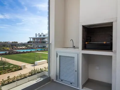 a kitchen with a sink and a window with a view at Green 2 Apartment by Stay ici Algarve Holiday Rental in Albufeira