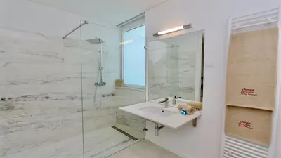a bathroom with a sink and a glass shower at Vila Leonor - Clever Details , Central Vilamoura, Sleeps 6, luxury, walking distance in Vilamoura