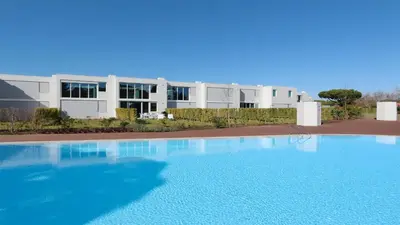 a large swimming pool in front of a building at Vila Leonor - Clever Details , Central Vilamoura, Sleeps 6, luxury, walking distance in Vilamoura