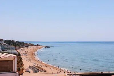 a group of people on a beach with the ocean at Old Fisherman's Corner 16 - Centro Old Town Albufeira in Albufeira