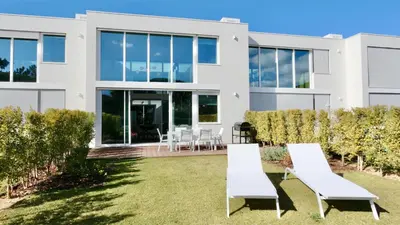 a white house with white furniture in the yard at Villa Emilia - Clever Details , Central Vilamoura, Sleeps 6, luxury, walking distance in Vilamoura