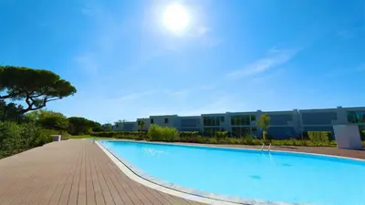 a large swimming pool in front of a building at Villa Emilia - Clever Details , Central Vilamoura, Sleeps 6, luxury, walking distance in Vilamoura