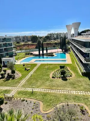 a bathroom with a shower and a tub and a sink at Superbe appartement spacieux avec terrasse vue piscine in Vilamoura