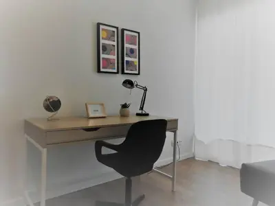 a living room with a gray couch and a mirror at Black&light in Faro in Faro