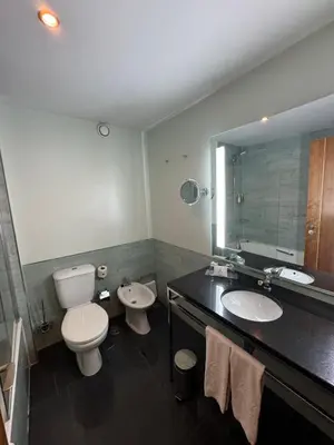 a bathroom with a toilet and a sink and a mirror at Semanas 30 e 24 Vila Galé Cerro Alagoa in Albufeira