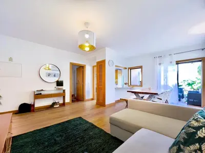 a kitchen with wooden cabinets and stainless steel appliances at ALBUFEIRA BEACH in Albufeira