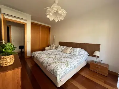 a bedroom with a bed and a large window at ALBUFEIRA BEACH in Albufeira
