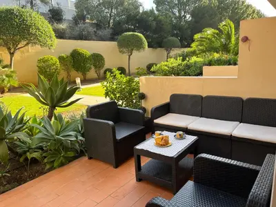 a patio with chairs and a couch and a table at ALBUFEIRA BEACH in Albufeira