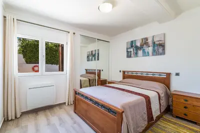 a bedroom with a bed and a window at Appartement ALGARDEN Olhos d'Agua in Olhos de Água