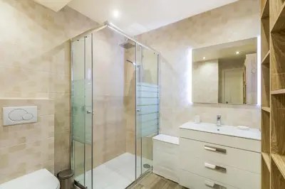 a bathroom with a shower and a toilet and a sink at Appartement ALGARDEN Olhos d'Agua in Olhos de Água