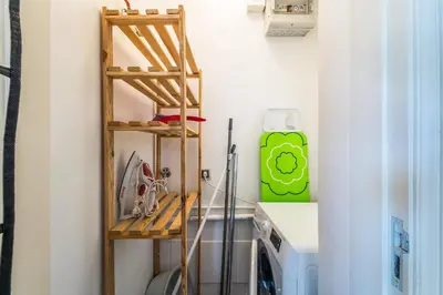 a kitchen with a ladder next to a stove and a refrigerator at Appartement ALGARDEN Olhos d'Agua in Olhos de Água