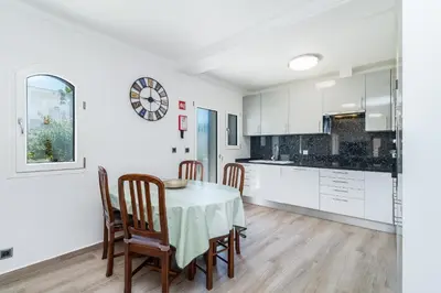a kitchen and dining room with a table and chairs at Appartement ALGARDEN Olhos d'Agua in Olhos de Água