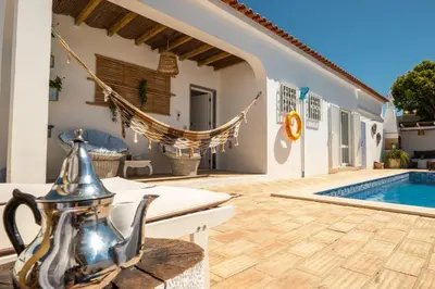 a villa with a pool and a tea kettle on a patio at Villa O Canto da Parra - Hot Jacuzzi - Swimming Pool - WIFI - BY BEDZY in Galé