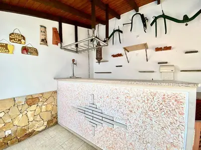 a kitchen with a counter with artwork on the wall at Palma's Place Casanova Villa #WIFI#HEATEDPOOL#RELAX in Faro