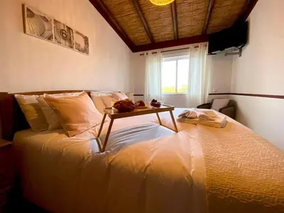 a bedroom with a bed with a table on it at Palma's Place Casanova Villa #WIFI#HEATEDPOOL#RELAX in Faro