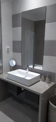a bathroom with a white sink and a mirror at Appartement Standing au coeur d'Albufeira in Albufeira