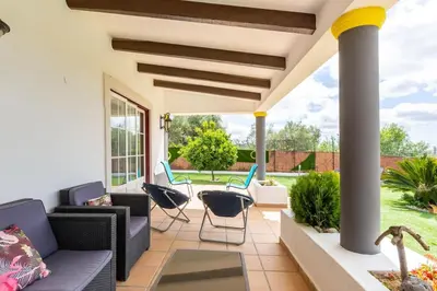 a patio with couches and chairs on a porch at Monte Velho in Loulé