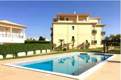 a villa with a swimming pool and a house at São João das Areias By Albufeira Rental in Albufeira