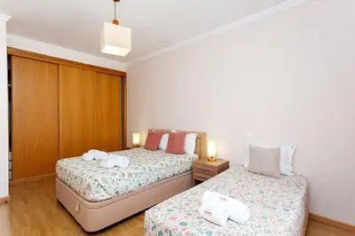 a bedroom with two beds with towels on them at São João das Areias By Albufeira Rental in Albufeira