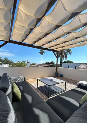 a living room with a couch and a table at Einzigartige Landhaus-Villa mit Pool, Sauna, Bar und BBQ in Boliqueime