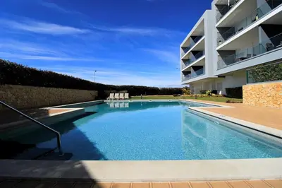 a swimming pool in front of a building at Albufeira Prestige With Pool by Homing in Albufeira