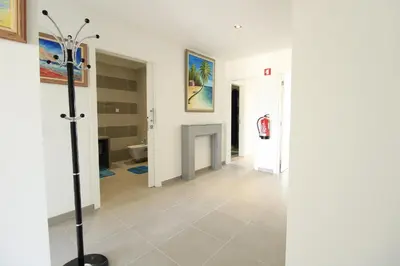 a hallway with white walls and a tile floor at Albufeira Prestige With Pool by Homing in Albufeira