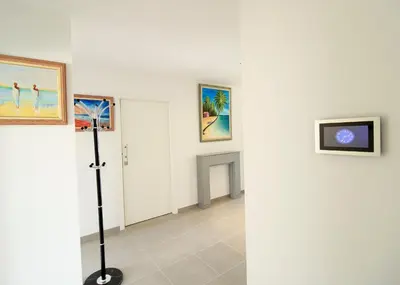 a white room with paintings on the wall and a lamp at Albufeira Prestige With Pool by Homing in Albufeira
