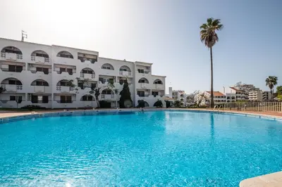 a balcony with a table and chairs and a pool at #079 T1 Vale Mangude by Home Holidays in Albufeira