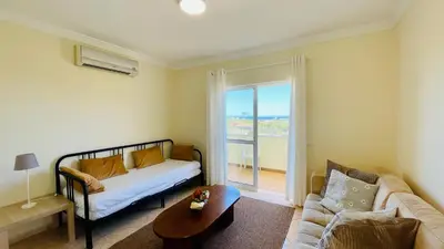 a living room with a couch and a table at Lara Lima by Check-in Portugal in Albufeira