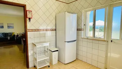 a white refrigerator in a room with a window at Lara Lima by Check-in Portugal in Albufeira
