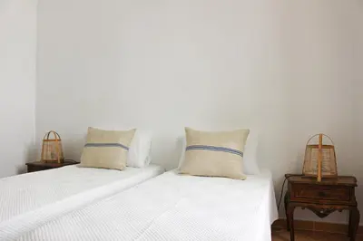 two beds with white sheets and pillows in a room at Santa Clara Old Town in Albufeira