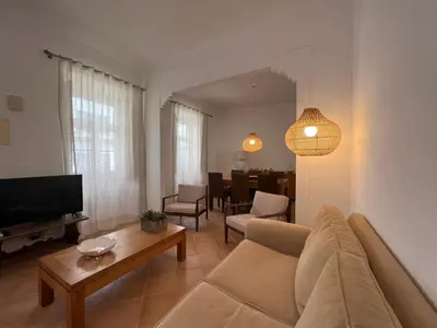 a living room with a couch and a tv and a table at Santa Clara Old Town in Albufeira
