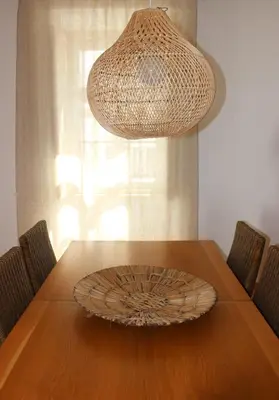 a dining room table with a chandelier and a wooden table with chairs at Santa Clara Old Town in Albufeira