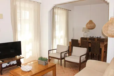 a living room with a couch and a dining room at Santa Clara Old Town in Albufeira