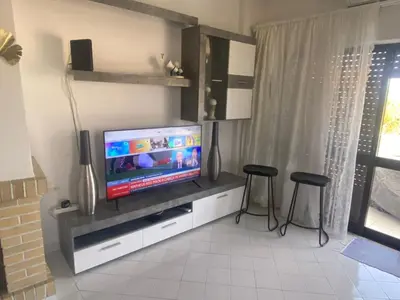a dining table and chairs in a living room at Blue Algarve in Albufeira