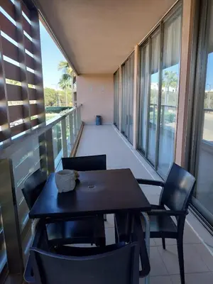 a dining room with a table and chairs on a balcony at Salgados, Vila das Lagoas in Albufeira